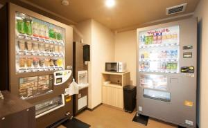 a soda machine in a store with drinks in it at Dormy Inn Express Matsue in Matsue