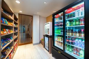 a grocery store aisle with a large display of drinks at Holiday Inn Express & Suites - Romeoville - Joliet North, an IHG Hotel in Romeoville