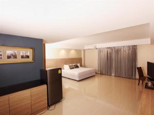 a bedroom with a bed and a tv in a room at Avana Laem Chabang Boutique Hotel in Ban Laem Chabang