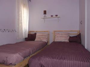 two beds sitting next to each other in a room at Cozy Apartment Near The Beach in Barcelona