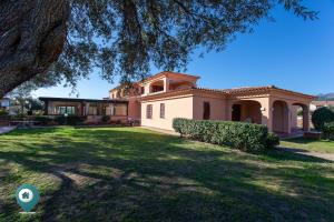 a house with a large yard in front of it at La Cinta 1 in San Teodoro