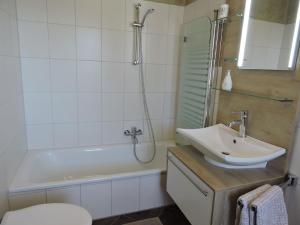 a bathroom with a sink and a shower and a toilet at Appartement - Haus Winterberg in Winterberg