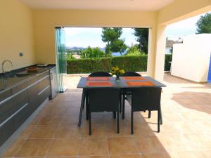 a kitchen with a table with chairs and a counter at Villa El Descanso by Interhome in Calpe