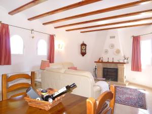 a living room with a table with wine bottles on it at Villa El Descanso by Interhome in Calpe