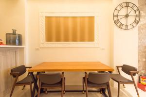a dining room with a wooden table and chairs at Miller Homestay in Wujie