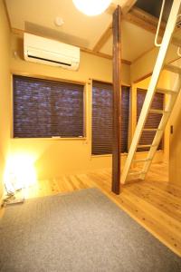 a room with a loft bed and a vaulted ceilings at Mibuan in Kyoto