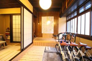 two bikes are parked in a room with windows at Mibuan in Kyoto
