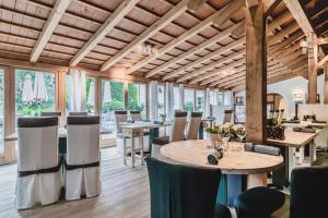 a dining room with a table and chairs at Hotel Bad Schörgau in Sarntal