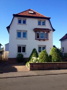 a large white house with a red roof at Ferienwohnung Anke Kaufmann in Miltenberg