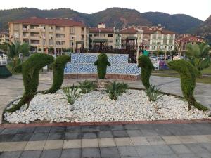 a sculpture of plants in a park with buildings in the background at Fethiye City Aparts in Fethiye