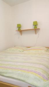 a bed with two green lamps on top of it at Kavárna Lucie s ubytováním in Horní Těrlicko