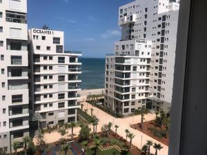 a view of two tall buildings and the ocean at Charming Appartement With a Beautifull View in Casablanca