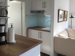 a kitchen with white cabinets and a counter top at Held Ursel in Neustadt in Holstein