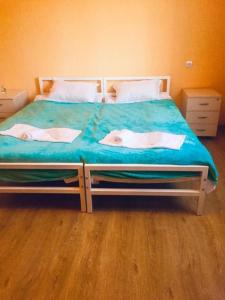 a bedroom with a bed with two dolls on it at Lali in Tbilisi City