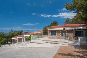 a building with a balcony on a street at Iliovasilema in Platy