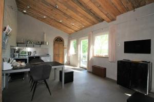 a living room with a table and a kitchen with a tv at Studio Rent Jamzes in Hoogerheide +46 photos