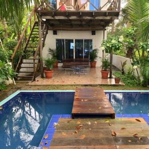 a house with a swimming pool with a wooden deck at Hostal Hilltop Capurgana in Capurganá