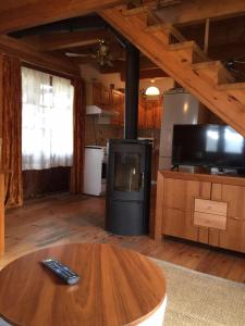 a living room with a tv and a table with a remote control at Domek przy plaży in Narty