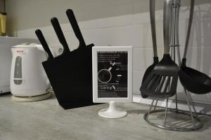 a kitchen counter with cooking utensils and a box at Апартаменты Park & House 8 рядом с источником и парком in Essentuki