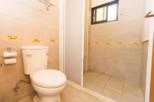a bathroom with a toilet and a shower at 曉翠軒親子民宿 in Wujie