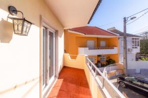 a balcony with a view of a house at Elegant Vintage Villa- Parede in Parede