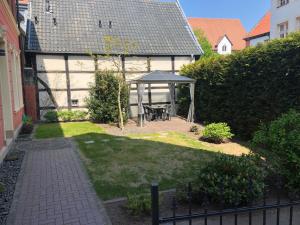 a backyard with a gazebo and a picnic table at Hotel Johann in Warendorf