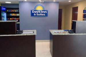 a days inn and suites store with a sign on the wall at Days Inn & Suites by Wyndham Tampa/Raymond James Stadium in Tampa