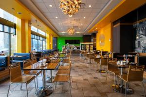 a dining room with tables and chairs and a chandelier at Travelodge by Wyndham Downtown Chicago in Chicago