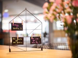 a glass display on a table with signs on it at Novotel Wrocław City in Wrocław