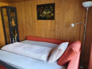 a bed with two pillows on it in a room at Apartment Lilalama in Grindelwald