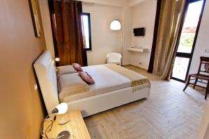 a bedroom with a bed and a table in it at B&B Shining in Avola