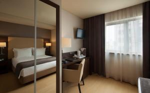 
a hotel room with a large bed and a large window at TURIM Iberia Hotel in Lisbon
