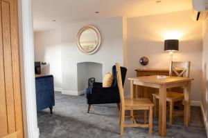 a dining room with a table and a chair at Manifold Dale in Ashbourne