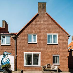 a brick house with a mural on the side of it at West 7 in Zandvoort