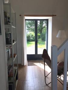 a room with a door leading to a yard at La Colline des Renards in Locmaria-Berrien
