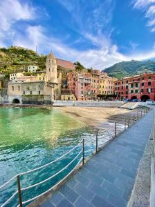 a group of buildings next to a body of water at La Polena Camere Vernazza - Suite vista mare in Vernazza +37 photos