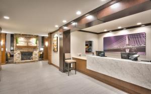 a lobby with a reception desk and a fireplace at Staybridge Suites - Gainesville I-75, an IHG Hotel in Gainesville
