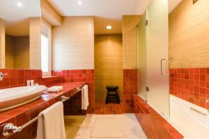 a bathroom with red tiles and a sink at The Albatroz Hotel in Cascais