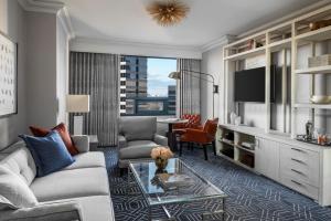 a living room with a couch and a table at Four Seasons Hotel Atlanta in Atlanta