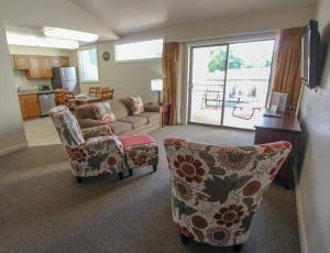 a living room with a couch and chairs and a kitchen at Multi Resorts at Villas at Southgate in St. George