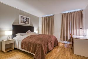 Postel nebo postele na pokoji v ubytování Trondheim Leilighetshotel