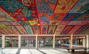 a brightly colored ceiling in a building with benches at Cinnamon Bentota Beach - Signature Selection in Bentota