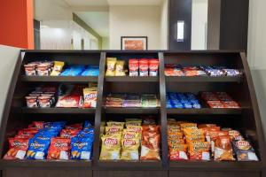 a shelf filled with lots of different types of chips at Staybridge Suites - Miami International Airport by IHG in Miami