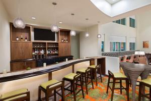 a bar in a restaurant with stools at Staybridge Suites - Miami International Airport by IHG in Miami