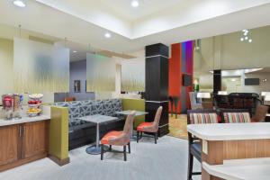 a lobby with colorful furniture and tables and chairs at Staybridge Suites - Miami International Airport by IHG in Miami