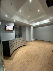 an empty room with a counter and a television on a wall at izZzleep WTC Mexico (world trade center Mexico) in Mexico City