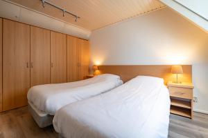 Postel nebo postele na pokoji v ubytování Hotel Almenum - het sfeervolle stadslogement -