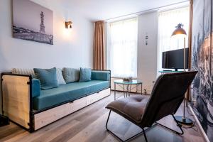 TV a/nebo společenská místnost v ubytování Hotel Almenum - het sfeervolle stadslogement -