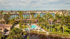 a large building with trees and palm trees at Holiday Inn San Diego Bayside, an IHG Hotel in San Diego