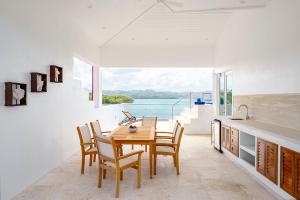 a dining room table and chairs with a view of the ocean at Windjammer Landing Villa Beach Resort in Gros Islet